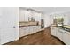 Bright kitchen with white cabinets, granite countertops, and stainless steel appliances at 622 Rocky Creek Pt, Woodstock, GA 30188