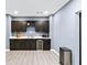 Kitchenette with dark cabinets, stainless steel appliances, countertop and plenty of storage at 622 Rocky Creek Pt, Woodstock, GA 30188