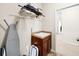 Cozy laundry area with a wash sink, shelving, ironing board and door to the main part of the house at 622 Rocky Creek Pt, Woodstock, GA 30188