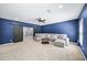 Cozy living room with plush seating, ceiling fan, and barn doors leading to other spaces at 622 Rocky Creek Pt, Woodstock, GA 30188