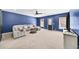 Spacious living room featuring plush seating, a ceiling fan, and lots of natural light at 622 Rocky Creek Pt, Woodstock, GA 30188