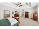 Primary bedroom boasts neutral carpeting and connects to the primary bathroom at 622 Rocky Creek Pt, Woodstock, GA 30188