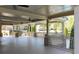 Expansive covered outdoor space with stone columns, ceiling fans, and scenic neighborhood views at 622 Rocky Creek Pt, Woodstock, GA 30188