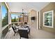 Relaxing screened porch with comfortable seating, ceiling fan, and outdoor view; perfect for entertaining at 622 Rocky Creek Pt, Woodstock, GA 30188