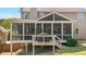 A view of the screened porch featuring a grill and stairs down to the backyard at 622 Rocky Creek Pt, Woodstock, GA 30188