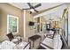 Spacious screened porch featuring ceiling fans, comfortable seating, and a built-in television for outdoor enjoyment at 622 Rocky Creek Pt, Woodstock, GA 30188