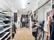 Well-organized walk-in closet with custom shelving, drawers, and rods for all your storage needs at 622 Rocky Creek Pt, Woodstock, GA 30188
