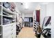 Expansive walk-in closet featuring custom shelving, drawers, and ample storage space for clothes and accessories at 622 Rocky Creek Pt, Woodstock, GA 30188