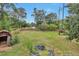 Spacious backyard featuring grass, trees, a shed and a trampoline at 8977 Teal Ln, Jonesboro, GA 30236