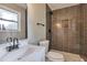 Modern bathroom featuring a stylish vanity and a tiled shower with a built-in niche at 8977 Teal Ln, Jonesboro, GA 30236