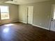 Bright bedroom with hardwood floors, neutral walls, and a window for natural light at 8977 Teal Ln, Jonesboro, GA 30236