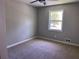 Cozy bedroom with neutral carpet and a window offering a pleasant view of the outside at 8977 Teal Ln, Jonesboro, GA 30236