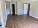 Spacious room featuring laminate floors, grey walls, and multiple entrances at 8977 Teal Ln, Jonesboro, GA 30236
