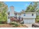 Charming exterior view of a two-story home with a wood deck and attached two-car garage at 8977 Teal Ln, Jonesboro, GA 30236