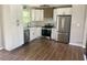 A renovated kitchen featuring white cabinets, stainless steel appliances, and modern countertops at 8977 Teal Ln, Jonesboro, GA 30236