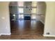 Open-concept living room featuring a fireplace, high ceiling, and access to an upstairs kitchen at 8977 Teal Ln, Jonesboro, GA 30236