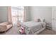 Comfortable bedroom featuring large windows, plush carpet and light pink accents at 105 Glenmore Ln, Mcdonough, GA 30253
