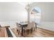 Bright dining room with hardwood floors, modern chandelier, and a large window offering natural light at 105 Glenmore Ln, Mcdonough, GA 30253