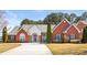Beautiful, brick single-story home with well-manicured lawn and a curved driveway leading to an arched front entryway at 105 Glenmore Ln, Mcdonough, GA 30253