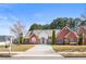 Charming single-story brick home with a manicured lawn, featuring an arched entryway and symmetrical window placement at 105 Glenmore Ln, Mcdonough, GA 30253