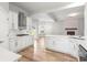 Beautiful open kitchen flows into living area, featuring white cabinets, an island, and stainless steel appliances at 105 Glenmore Ln, Mcdonough, GA 30253