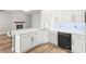 Bright kitchen boasts quartz countertops, subway tile backsplash, stainless steel appliances, and wood flooring at 105 Glenmore Ln, Mcdonough, GA 30253