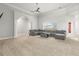 Spacious living room with vaulted ceilings, plush carpet, and a comfortable sectional sofa at 105 Glenmore Ln, Mcdonough, GA 30253