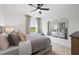 This is a serene bedroom with a ceiling fan, window, and tasteful decor at 1636 Tide Mill Rd, Cumming, GA 30040