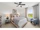 Comfortable bedroom featuring a bed with soft linens, side tables, and a large window with natural light at 1636 Tide Mill Rd, Cumming, GA 30040