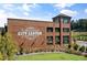 Attractive brick building exterior displaying the Cumming City Center logo with well manicured shrubbery and lawn at 1636 Tide Mill Rd, Cumming, GA 30040
