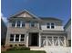 Charming two-story home with brick and siding, showcasing a well-manicured lawn and inviting entrance at 1636 Tide Mill Rd, Cumming, GA 30040