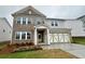Charming two-story home with brick accents, landscaped yard, and attached two-car garage at 1636 Tide Mill Rd, Cumming, GA 30040