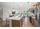 Open-concept kitchen with stainless appliances, center island, pendant lights, and hardwood floors at 1636 Tide Mill Rd, Cumming, GA 30040