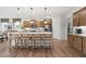 Spacious kitchen island with counter seating, stainless steel appliances, and wood floors at 1636 Tide Mill Rd, Cumming, GA 30040