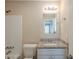 Bathroom with granite countertop vanity, white fixtures and tiled shower at 6520 Emerald Pointe Cir, Atlanta, GA 30349