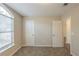 Bright, airy bedroom boasts carpet, neutral paint and a large window at 6520 Emerald Pointe Cir, Atlanta, GA 30349