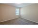 Bedroom with plush carpet, neutral walls and a large window for natural light at 6520 Emerald Pointe Cir, Atlanta, GA 30349