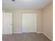 Bedroom with plush carpet, neutral walls, closet and two doors at 6520 Emerald Pointe Cir, Atlanta, GA 30349