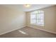 Bedroom featuring plush carpet, neutral walls, and bright window at 6520 Emerald Pointe Cir, Atlanta, GA 30349