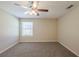 Neutral bedroom features plush carpet, natural light, and ceiling fan at 6520 Emerald Pointe Cir, Atlanta, GA 30349