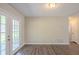 Dining area with french doors that bring in natural light, hardwood floors throughout at 6520 Emerald Pointe Cir, Atlanta, GA 30349