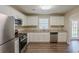 Modern kitchen with stainless steel appliances, granite countertops, and white cabinets at 6520 Emerald Pointe Cir, Atlanta, GA 30349