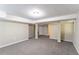 Open basement with carpeted floors, basic lighting, and support beams for added structural support at 8596 Timberlane Dr, Douglasville, GA 30134