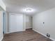 Unfinished basement space with wood-look flooring, closet, and utility hookups; ready to be finished to your liking at 8596 Timberlane Dr, Douglasville, GA 30134