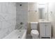 Updated bathroom featuring a tub with white marble tile, sink with cabinet, and neutral walls at 8596 Timberlane Dr, Douglasville, GA 30134