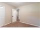 Neutral bedroom features plush carpeting, a closet, and an open doorway to the rest of the house at 8596 Timberlane Dr, Douglasville, GA 30134