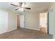 Spacious bedroom with plush carpet, ceiling fan, closet and bathroom at 8596 Timberlane Dr, Douglasville, GA 30134