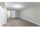 This simple bedroom is painted in a neutral color with carpeted floors and includes a single light fixture at 8596 Timberlane Dr, Douglasville, GA 30134
