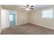 Bedroom features a ceiling fan, plush carpet, and a view to another room at 8596 Timberlane Dr, Douglasville, GA 30134