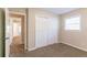 Bedroom with plush carpeting, closet, and a view to another room at 8596 Timberlane Dr, Douglasville, GA 30134